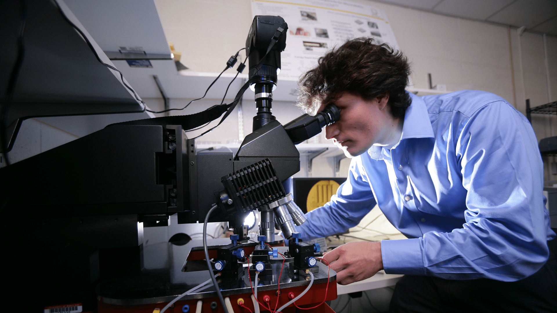 Ivan Penskiy with the equipment and microscopes for the probe station characterization done in the Micro Robotics Lab. 